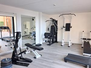 a gym with several treadmills and exercise equipment at Hotel Florida in Limone sul Garda