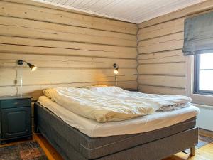a bedroom with a bed in a room with wooden walls at Tyinkrysset panorama in Tyinkrysset +17 photos