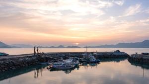 a group of boats are docked at a dock at Yeosu Wayo Ocean View Pension in Yeosu +2 photos