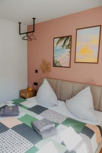 a bed with two pillows on it in a room at sleepArt beach in Celle