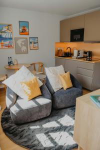 a living room with a couch and a chair at sleepArt beach in Celle