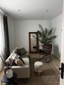 a living room with a couch and a mirror at Coastal Sands Azores in Ribeira Grande