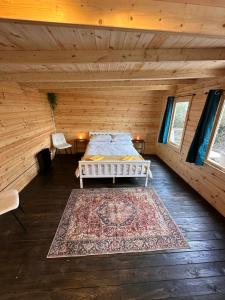 a bedroom with a bed in a log cabin at Buzzard Holt Hosting in Buckingham