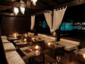 a room with tables and candles in a room at Hotiday Otranto Baia Resort in Otranto