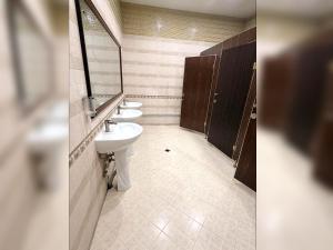 a bathroom with three sinks and a mirror at Hunnu Camp in Arhust