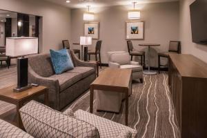 a living room with couches and chairs and tables at Staybridge Suites - Pecos by IHG in Pecos