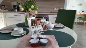 a table with cupcakes on top of it in a kitchen at Haus Burgsponheim in Burgsponheim +14 photos