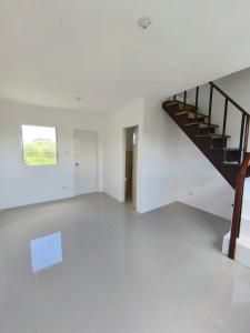 an empty room with a staircase in a house at camella palawan in Puerto Princesa City