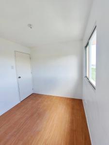 an empty room with a door and a window at camella palawan in Puerto Princesa City