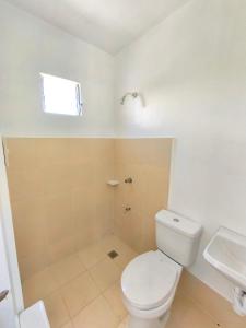 a bathroom with a toilet and a sink at camella palawan in Puerto Princesa City