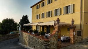 a building with a patio with a table on it at Palazzo Tiglio - A Small Luxury Hotels of the World in San Pancrazio +63 photos