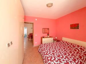 a bedroom with red walls and a bed in a room at LES PETITES MAISONS Maison rouge in Procida