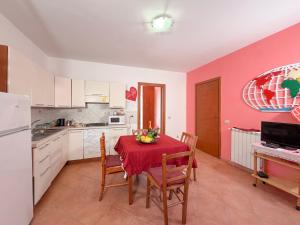 a kitchen with a table with a red table cloth at LES PETITES MAISONS Maison rouge in Procida
