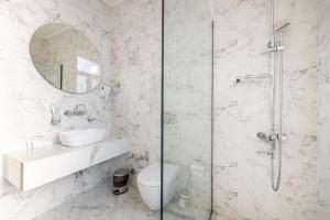 a bathroom with a shower and a toilet and a sink at Boutique Hotel Manufactura in Tbilisi City +64 photos