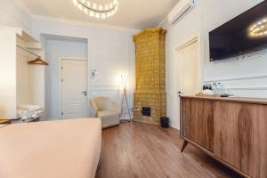 a living room with a television on a wall at Boutique Hotel Manufactura in Tbilisi City
