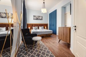 a hotel room with a bed and a chair at Boutique Hotel Manufactura in Tbilisi City