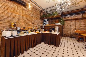 a restaurant with a counter and a brick wall at Boutique Hotel Manufactura in Tbilisi City