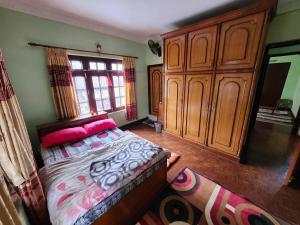 a bedroom with a bed with pink pillows on it at Om Raghav Homestay in Kathmandu +6 photos