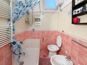 a bathroom with a toilet and a sink at LES PETITES MAISONS Maison rouge in Procida