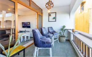 a room with two blue chairs and a table at Bstan Deluxe Beachfront in Diani Beach