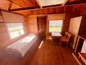 a bedroom with a bed and a table in a room at BiesChatki in Wetlina