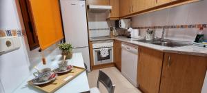 a kitchen with a table with two cups on it at Apartamento El Toboso in Alcalá de Henares