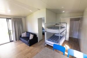 a room with two bunk beds and a chair at BIG4 Bridgetown in Bridgetown