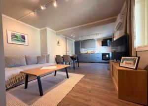 a living room with a couch and a table at Historic Strandgata 36 in Tromsø