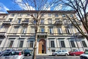 a large building with cars parked in front of it at CAV Juvarra in Turin