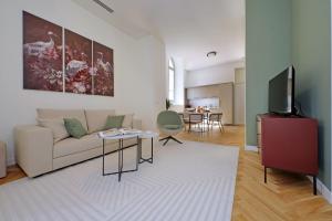 a living room with a couch and a tv at CAV Juvarra in Turin