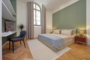 a bedroom with a bed and a desk and a chair at CAV Juvarra in Turin