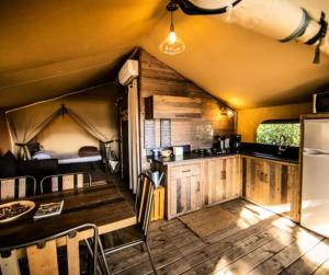 a kitchen and dining area of a tiny house at Cottage PARKS OLVA in Sartène