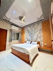 a bedroom with a large bed and a stone wall at Saiprasad suite & stay in Ellora +12 photos