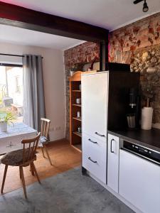 a kitchen with a white refrigerator and a table at Panoramablick am Herzoghof in Obing