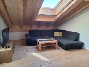 a living room with a blue couch and a table at Urlaub in Benediktbeuern in Benediktbeuern