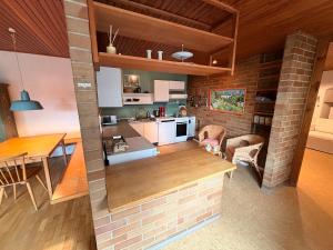 a kitchen and dining room with a brick wall at Donau Apartment in Sinzing +6 photos
