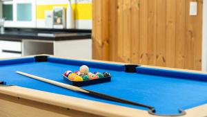 a bowl of balls sitting on a pool table at Gapyeong Haneuldari pet pension in Gapyeong