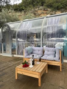 a couch sitting on a deck with a coffee table at Sial Skynest in Vlorë