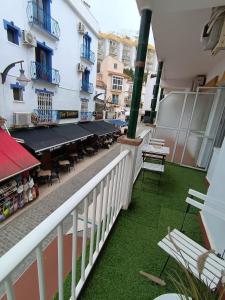 a balcony with a table and chairs on a building at Bajondillo Beach Apartment By Torremolinos On-line in Torremolinos