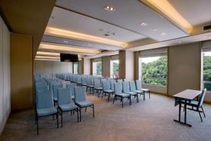 a row of chairs in a room with windows at Cititel Express Kota Kinabalu in Kota Kinabalu