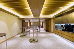 a hallway with two tables in a room at Cititel Express Kota Kinabalu in Kota Kinabalu