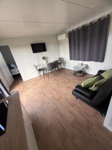 a living room with a couch and a table at Peaceful Farm Retreat - Luxury Cabins in Goulburn in Norwood