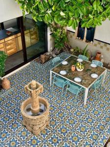 a patio with a table and a fountain on a tile floor at Villa Sa Torre Blanca in Colonia de Sant Pere