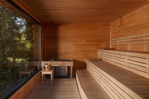 an outdoor sauna with a table and a chair at Resort po.spolu in Mokrovraty