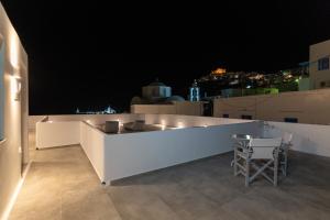 a white bar on the roof of a building at night at Bedspot Apartments Astipalaia in Pera Gyalos