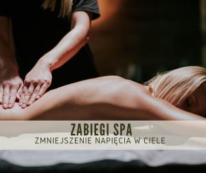a woman getting a massage from a therapist at Hotel Dębowy Biowellness & SPA Góry Sowie in Bielawa +188 photos