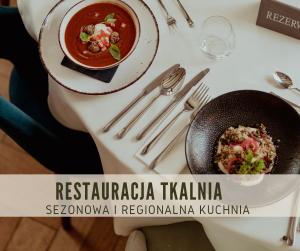 a table with a bowl of soup and a plate of food at Hotel Dębowy Biowellness & SPA Góry Sowie in Bielawa