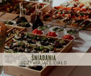 a buffet of appetizers and salads in wooden boxes at Hotel Dębowy Biowellness & SPA Góry Sowie in Bielawa