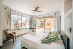 a bedroom with a bed and a large window at Villa Donna Cà con vista mare e piscina privata in Coccorino +75 photos