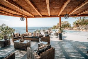 a patio with furniture and a view of the ocean at Villa Donna Cà con vista mare e piscina privata in Coccorino